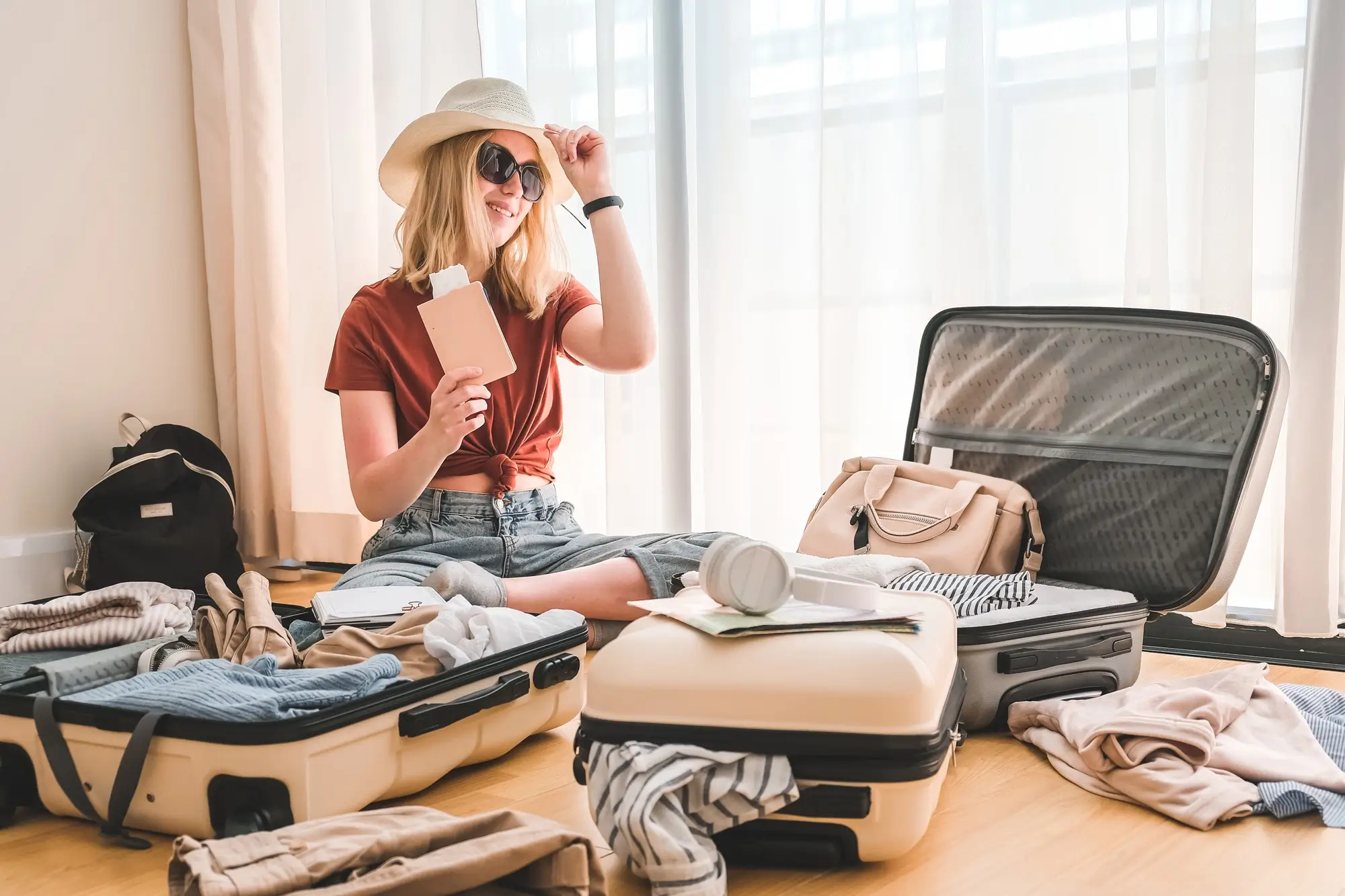 Travel. Staycation. Local travel new normal. Girl packing luggage in suitcase and travel documents Travel, tourism, vacation, relocation. Mental health and travel vacation Film grain